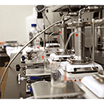 A laboratory with a row of machines and beakers