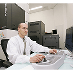 A KAUST researcher in a lab coat working on a computer