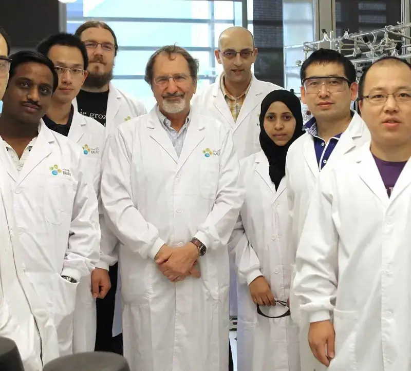 KAUST professors and students in lab coats facing the camera